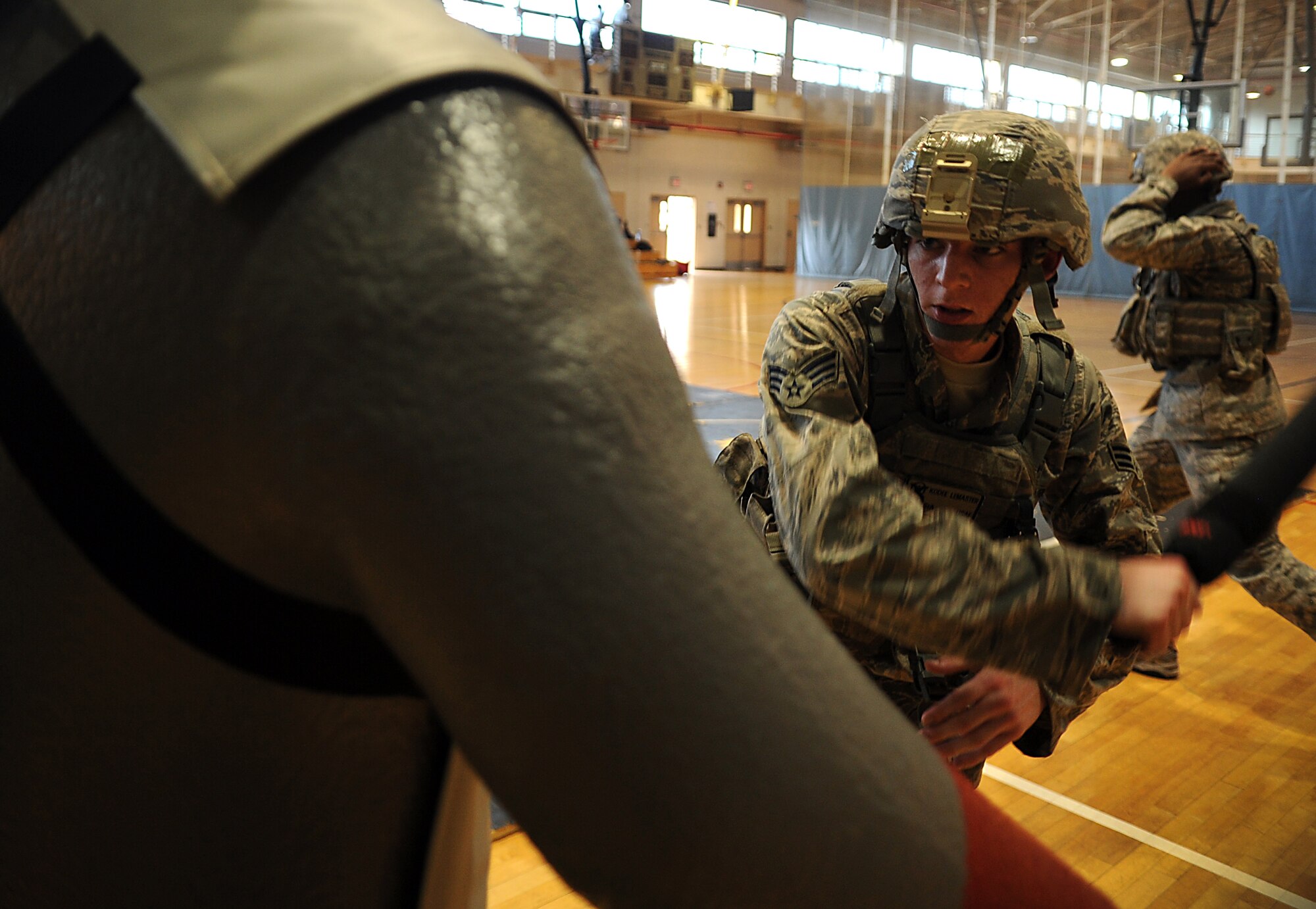 Senior Airman Kodee Lemaster, 51st Security Forces Squadron area supervisor, strikes a dummy during a combatives course at Osan Air Base, Republic of Korea, Sept. 18, 2013. The course allowed 51st SFS members to showcase all of the non-lethal tools and techniques the defenders learned. (U.S. Air Force photo/Staff Sgt. Sara Csurilla)