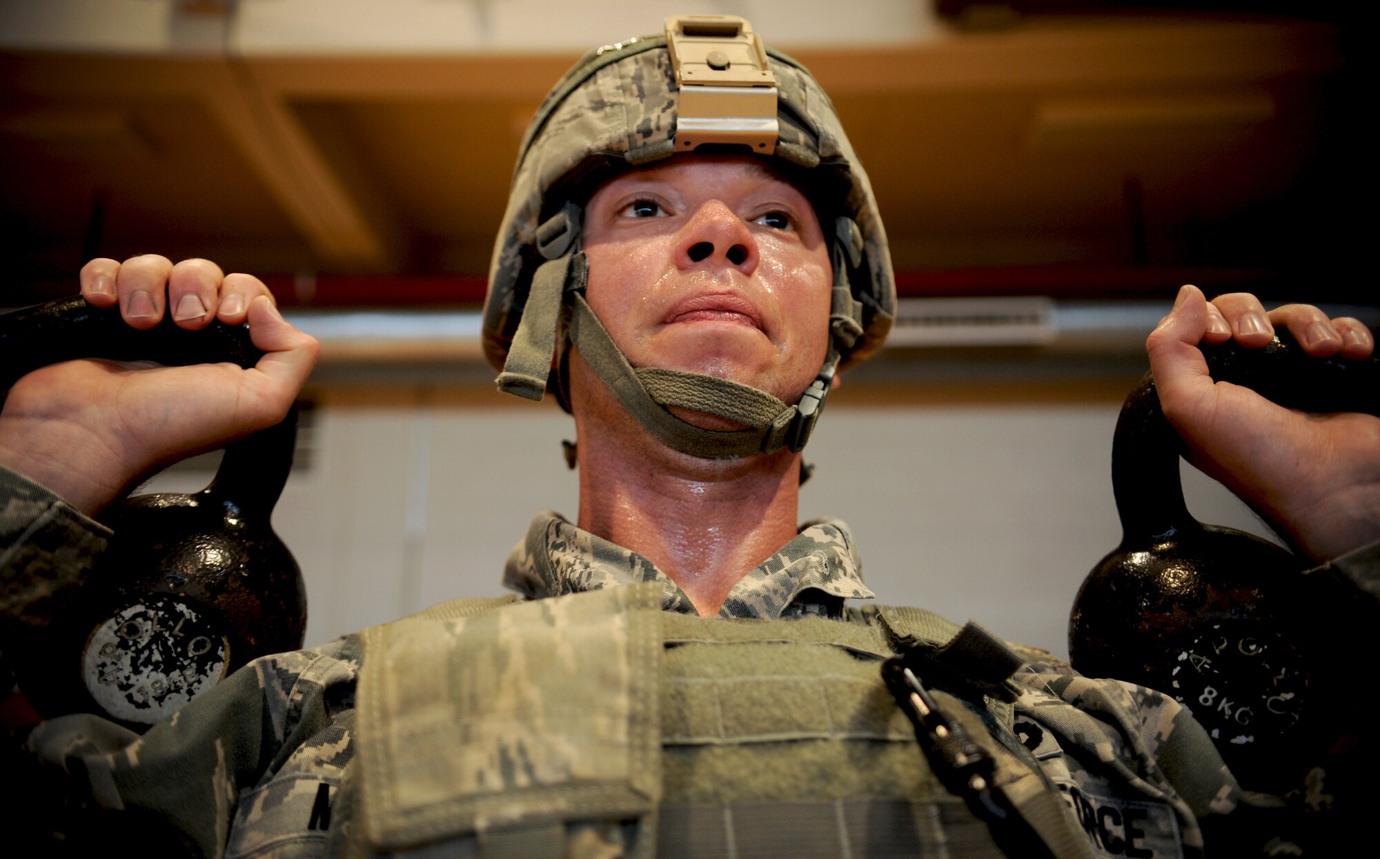 Tech. Sgt. John Miller, 51st Security Forces Squadron assistant delta flight leader, does kettle bell squats during a combatives course at Osan Air Base, Republic of Korea, Sept. 18, 2013. The course allowed 51st SFS members to showcase all of the non-lethal tools and techniques the defenders learned. (U.S. Air Force photo/Staff Sgt. Sara Csurilla)