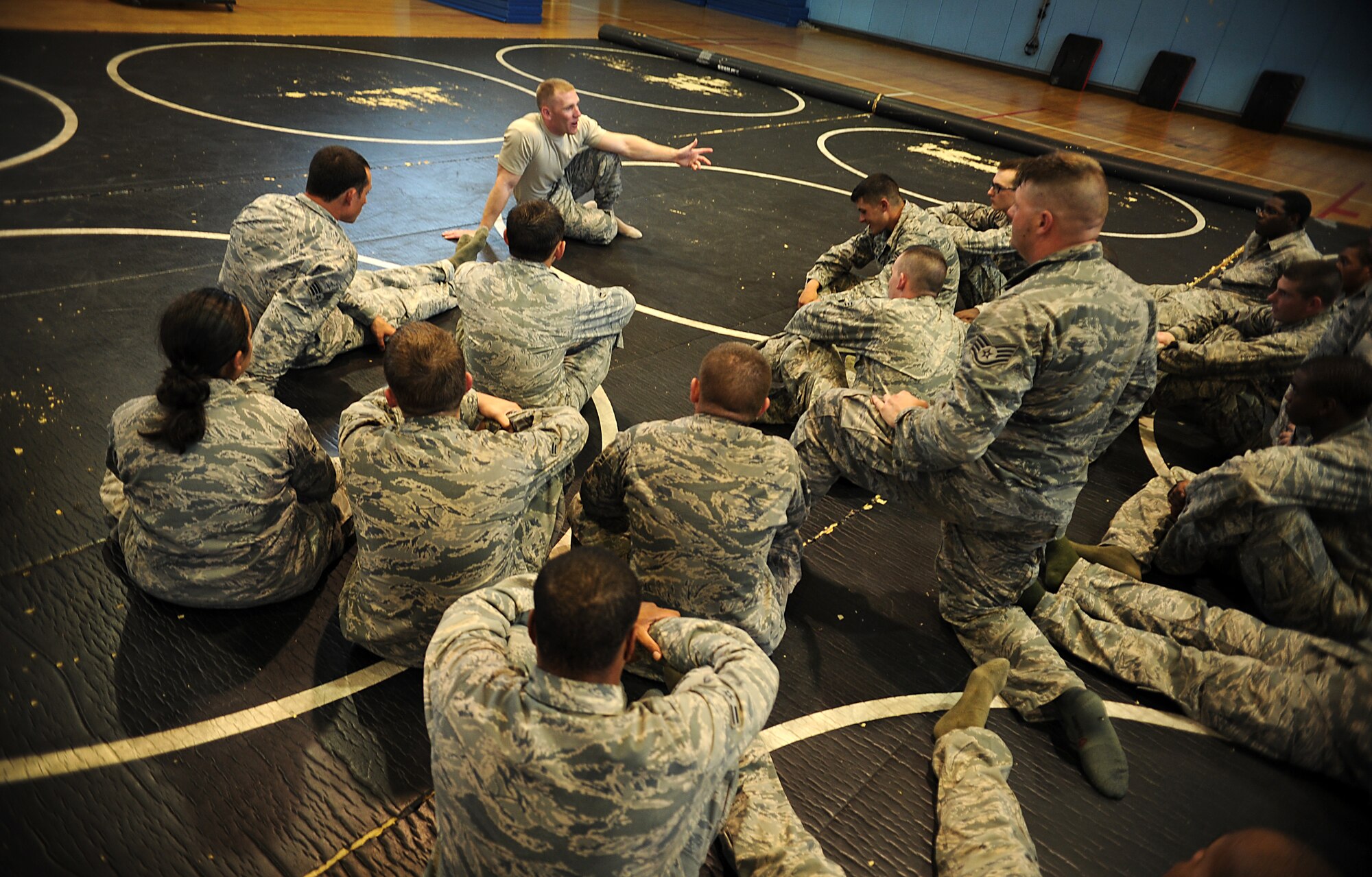 Staff Sgt. Stephen Barber, 51st Security Forces Squadron combat readiness course instructor, talks to members of the 51st SFS during a combatives course at Osan Air Base, Republic of Korea, Sept. 18, 2013. The course is designed to instill confidence and help the defenders think and react under pressure. (U.S. Air Force photo/Staff Sgt. Sara Csurilla)