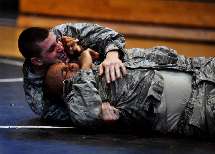 1st Lt. Michael Voto, 51st Security Forces Squadron bravo flight leader, grapples with another 51st SFS member during a combatives course at Osan Air Base, Republic of Korea, Sept. 18, 2013. The course reinforced basic unarmed offensive and defensive skills the defenders have learned previously. (U.S. Air Force photo/Senior Airman Siuta B. Ika)
