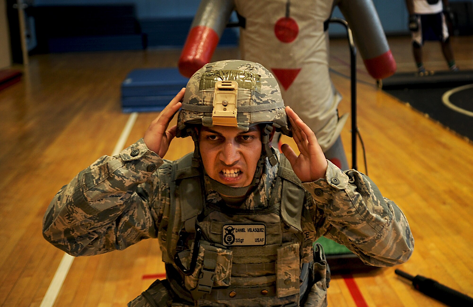 Staff Sgt. Daniel Velasquez, 51st Security Forces Squadron area supervisor, squats during a combatives course at Osan Air Base, Republic of Korea, Sept. 18, 2013. The course allowed 51st SFS members to showcase all of the non-lethal tools and techniques the defenders learned. (U.S. Air Force photo/Staff Sgt. Sara Csurilla)