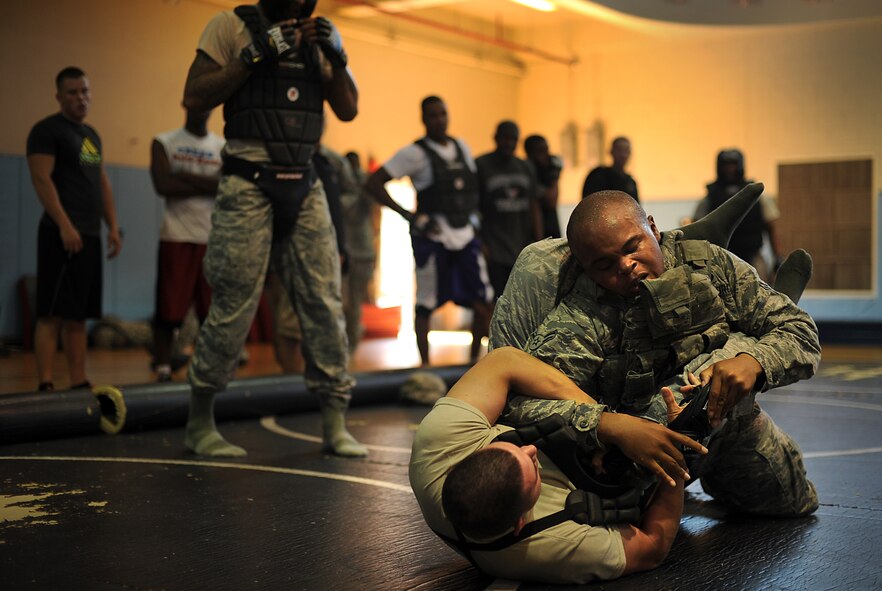 Senior Airman Joel Barajas, 51st Security Forces Squadron area supervisor, grapples with another 51st SFS member during a combatives course at Osan Air Base, Republic of Korea, Sept. 18, 2013. During the combatives course, participants learned and utilized grappling techniques to use in neutralizing would-be attackers. (U.S. Air Force photo/Staff Sgt. Sara Csurilla)