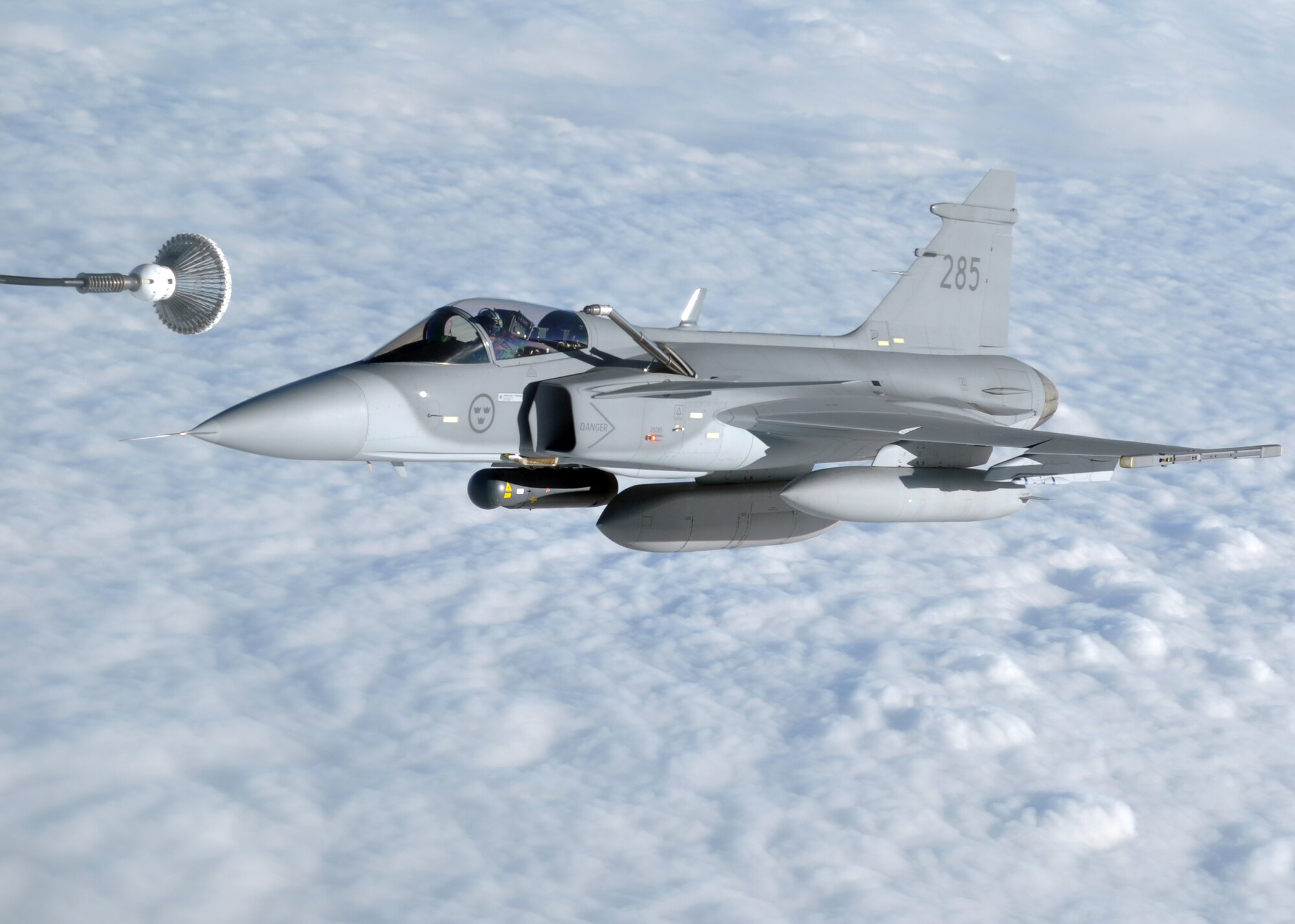 A Swedish JAS-39 Gripen prepares to take on fuel from a U.S. Air Force KC-135R Stratotanker during the Arctic Challenge exercise Sept. 20, 2013, over Norway. Sweden and other members of the Nordic Defense Cooperation train with the U.S. Air Force regularly to maintain proficiency operating in a multinational environment. (U.S. Air Force photo by 1st Lt. Christopher Mesnard/Released)