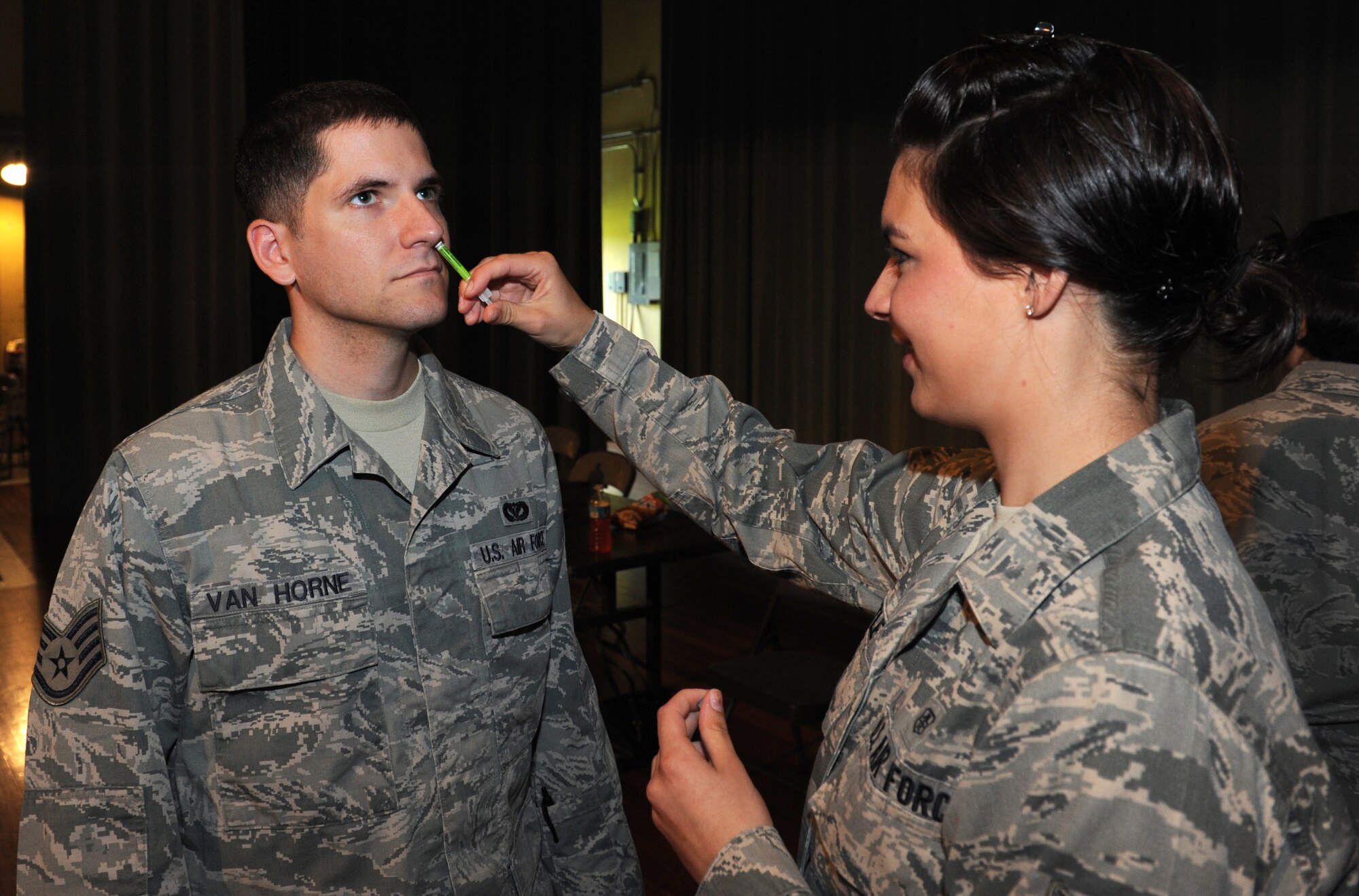 U.S. Air Force Airman 1st Class Ashlea Hittle, 18th Medical Operations Squadron aerospace medical technician, administers flu mist (live) on Kadena Air Base, Japan, Sept. 25, 2013. As flu season begins, all active duty and their dependants are required to receive the vaccine, which ensures they are covered until next flu season.(U.S. Air Force photo by Airman 1st Class Keith A. James)