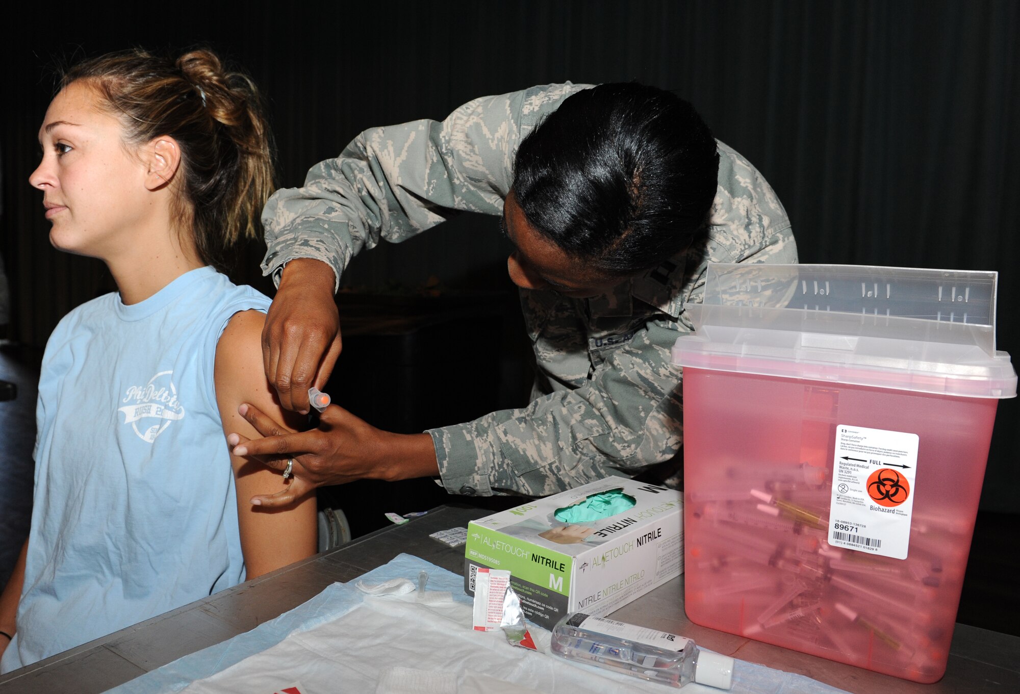 U.S. Air Force Capt. Sharina Galindo, 18th Medical Operations Squadron clinical nurse, administers an influenza vaccine (not live) to a patient on Kadena Air Base, Japan, Sept. 25, 2103. Patients are only administered the flu shot if under the age of two or over 50, unless they are allergic or have a status that prevents them from receiving the flu mist. (U.S. Air Force photo by Airman 1st Class Keith A. James)