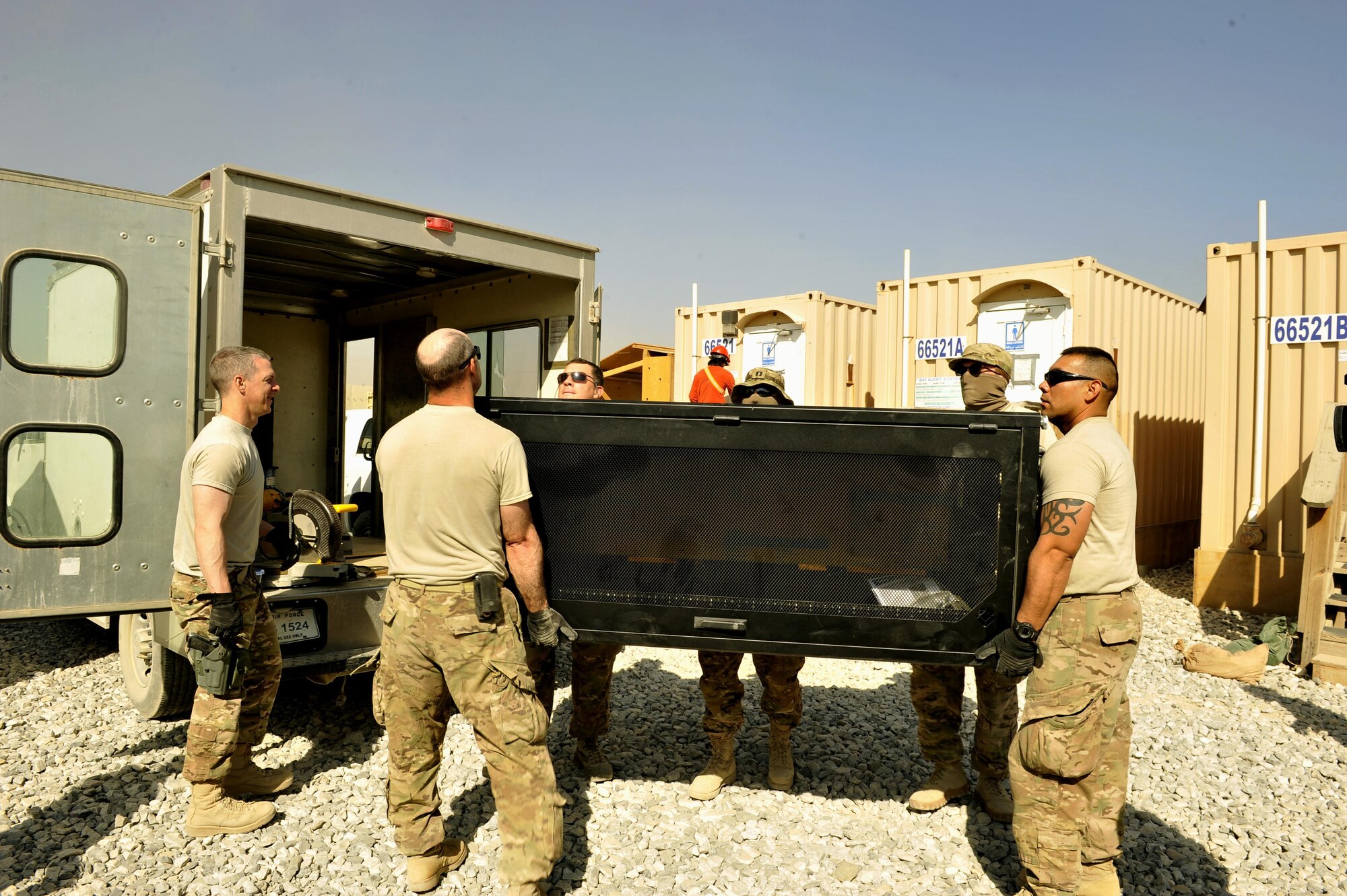 Airmen assigned to the 455th Expeditionary Communications Squadron unload a computer tower on Bagram Airfield, Afghanistan. The supplies will be used to build a communications equipment room and other systems. The Airmen spent three days setting up communication capability for future Jordanian coalition partners here. (U.S. Air Force photo/ Staff Sgt. Stephenie Wade)