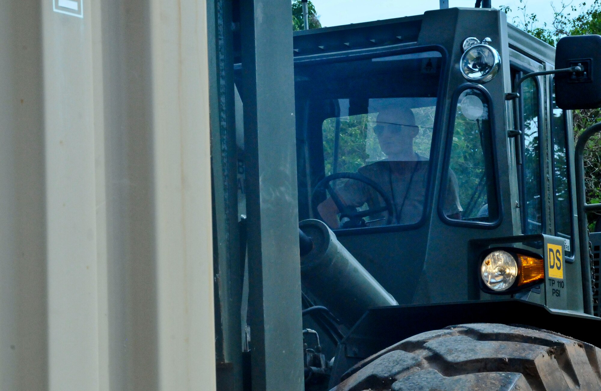 Airman 1st Class Chase Wood, 36th Munitions Squadron, munitions storage crew member, operates a 50K forklift, Sept. 24, 2013, on Andersen Air Force Base, Guam. The 36th MUNS is responsible for a storage area spanning more than 5,500 acres and encompassing 143 storage facilities, seven operating locations, 23 sited storage revetments, and 160 non-sited revetments. (U.S. Air Force photo by Airman 1st Class Amanda Morris/Released)