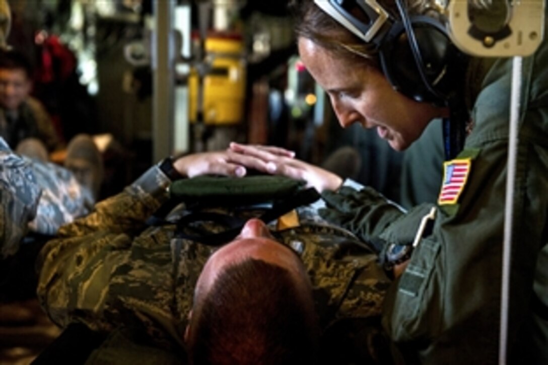 Air Force Reserve Maj. Kristina Spindel comforts a patient while flying in a WC-130J Hurricane Hunter aircraft during aeromedical evacuation training on Joint Base San Antonio-Lackland, Texas, Sept. 19, 2013. Spindel, a flight nurse, is assigned to the 433rd Aeromedical Evacuation Squadron. 