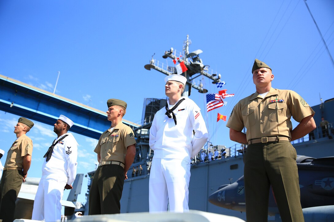 Marines and Sailors with the 13th Marine Expeditionary Unit and Boxer Amphibious  Ready Group man the rails as the USS Boxer passes under the Coronado Bridge to embark on its Western Pacific deployment from U.S. Navy Base San Diego, 2013. The Marines and Sailors will deploy for several months in support of theater requirements of Geographic Combatant Commanders.