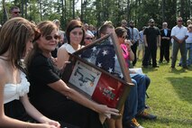 Family and friends gathered to honor the memory of retired Master Gunnery Sgt. Jerry G. Grier at a memorial service held at the aviation memorial aboard Marine Corps Air Station New River, Sept. 13. Grier served more than 26 years as a Marine and continued to serve his nation as a civilian contractor.