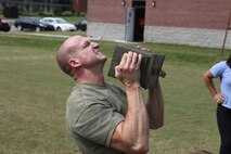 Marines competed in the High Intensity Tactical Training Ultimate Warrior Challenge at the HITT center aboard Marine Corps Air Station New River, Sept. 13. A Marine performs ammo can lifts as part of the modified maneuver under fire portion of the challenge.