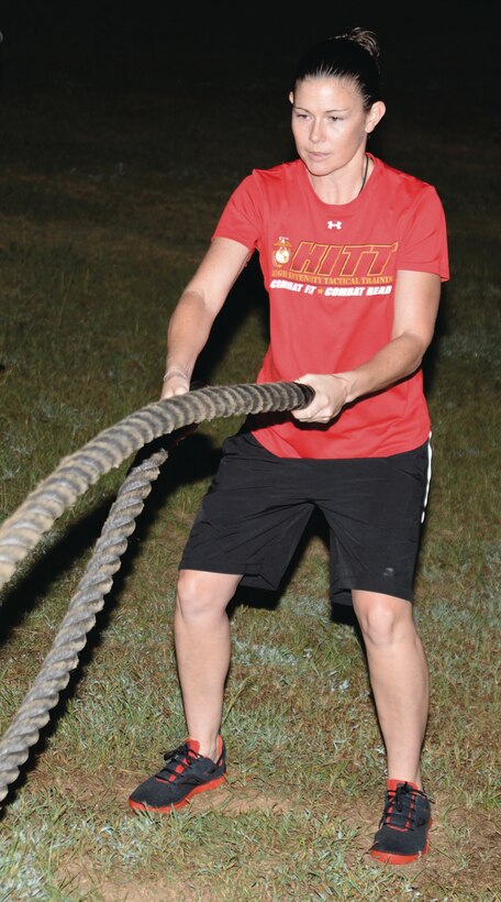 Whitney Hendrix, fitness director, Daniels Fitness Center, Marine Corps Logistics Base Albany, demonstrates a battle rope waves maneuver during the Ironman High-Intensity Tactical Training held here, Sept. 20. Hendrix coordinated each of the land-based HITT exercises, which commenced at MCLB Albany earlier this year.
