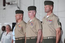 Sgt. Maj. Jeffrew M. Cullen, Lt. Col. Christian Marshberger and Sgt. Maj. Bradley W. Baiotto(left to right) stand at attention during a relief and appointment ceremony at the Marine Medium Tiltrotor Squadron (VMM) 365 hangar, Sept. 13. During the ceremony, Cullen stepped down as VMM-365 sergeant major and retired and Baiotto was appointed as the new squadron sergeant meajor. 