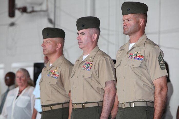 Sgt. Maj. Jeffrew M. Cullen, Lt. Col. Christian Marshberger and Sgt. Maj. Bradley W. Baiotto(left to right) stand at attention during a relief and appointment ceremony at the Marine Medium Tiltrotor Squadron (VMM) 365 hangar, Sept. 13. During the ceremony, Cullen stepped down as VMM-365 sergeant major and retired and Baiotto was appointed as the new squadron sergeant meajor. 
