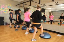 Members of the functional toning class participate in a circuit run through at the AS-4400 Fitness Center aboard Marine Corps Air Station New River, Sept. 9. The class performs Bosu ball toe touches as part of the cardio portion of the circuit.