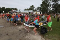 Headquarters and Headquarters Squadron Marines make a mad dash to the water's edge at the start of the H&HS regatta held at the marina aboard Marine Corps Air Station New River, Sept. 20.