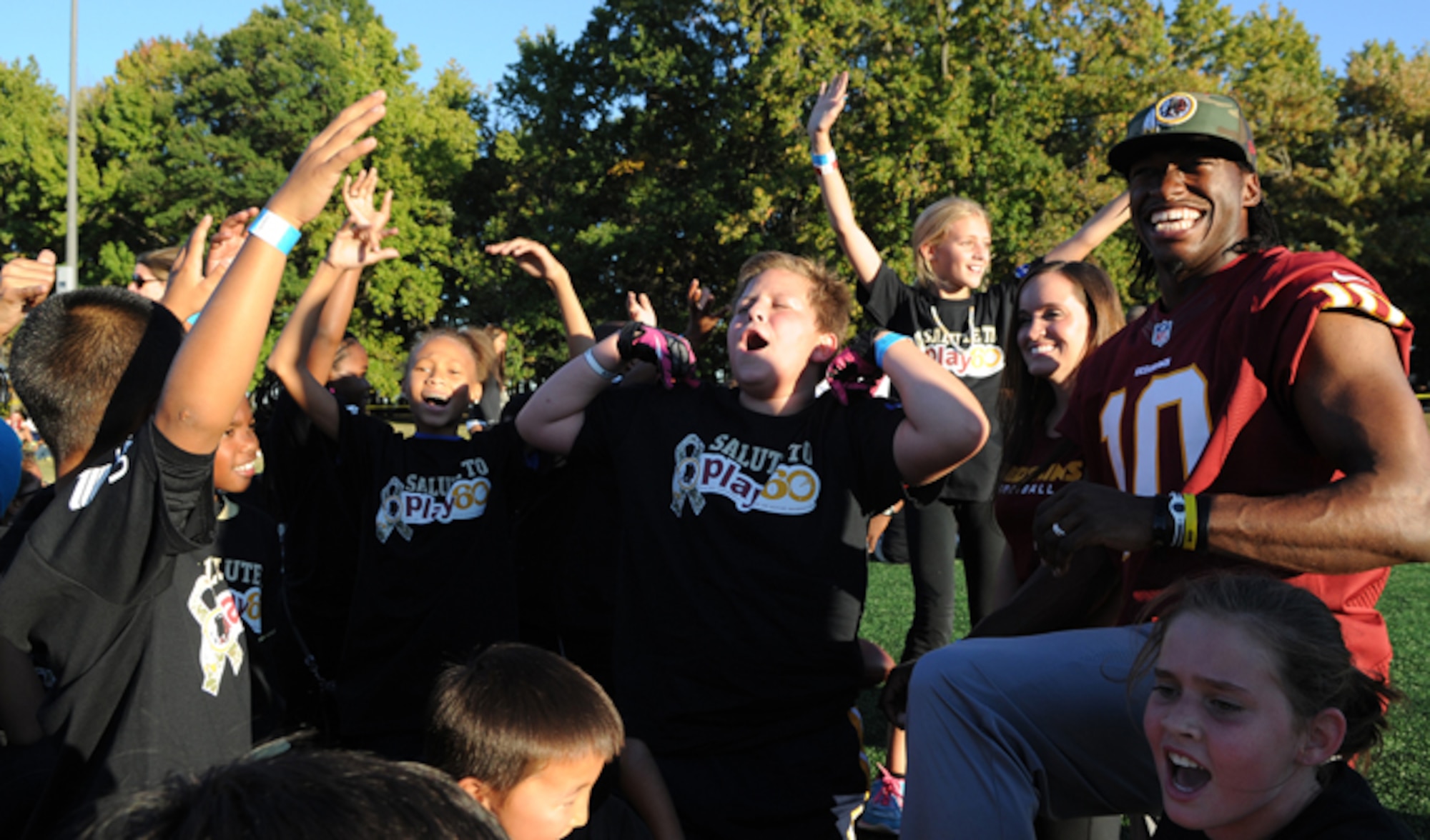 Children sound-off in support of their trainer Washington Redskins quarterback Robert Griffin III during the Salute to Play 60 Military Challenge Sept. 24, 2013, at Joint Base Andrews, Md. During the event Redskins players and celebrity trainers lead the children through stations that included passing drills, agility ladders, 40-yard dash and a lesson on health eating habits.