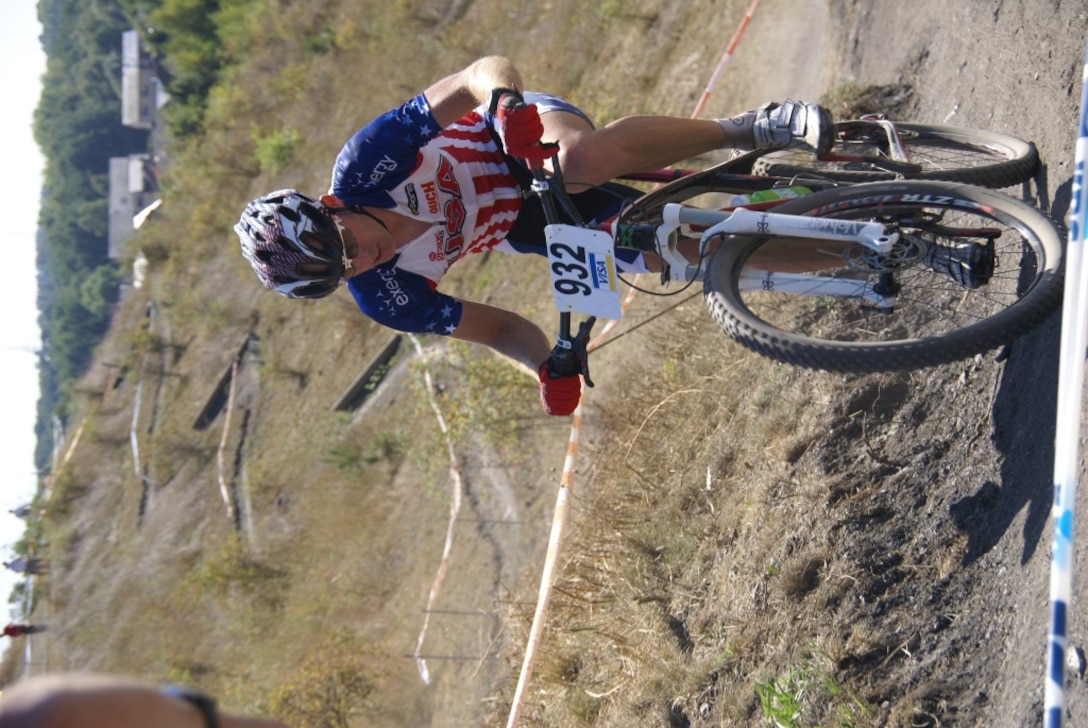 AWAI Chuck Jenkins (Navy) races up hill at the 1st ever Mountain Bike race at the 2013 CISM World Military Cycling Championship 2-6 September in Leopoldsburg, Belgium.  