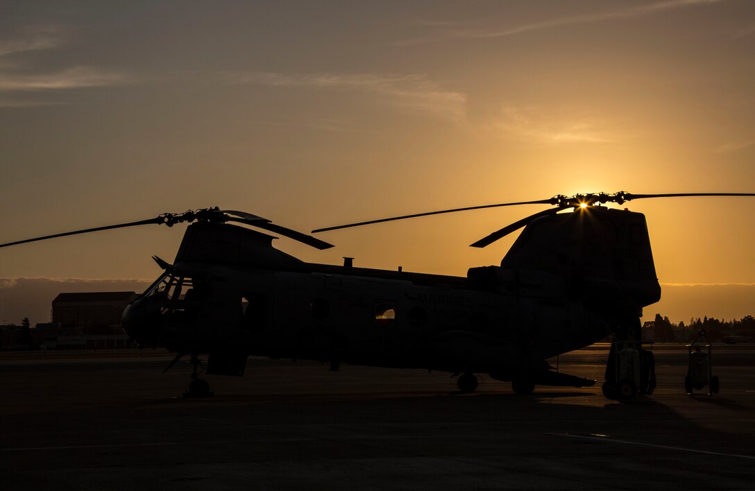 A CH-46E Sea Knight sits on the flight line during sunset aboard Moffett Federal Airfield, Calif., Sept. 11. Marines of HMM-268 conducted familiarization navigation flights and night confined area landing flights while in Moffett.