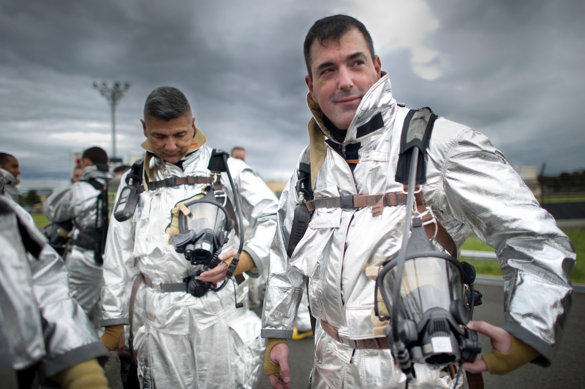 Col. Mark August, 374th Airlift Wing commander, and Chief Master Sgt. Manuel Roblesreynoso, 374th AW command chief, stand in bunker gear before live-fire training Sept. 26, 2013 at Yokota Air Base, Japan. Wing leadership trainied with fire fighters from the Yokota Fire Department to gain the experiance of wearing the gear and putting out a real fire. (U.S. Air Force photo by Staff Sgt Stacy Moless/released)