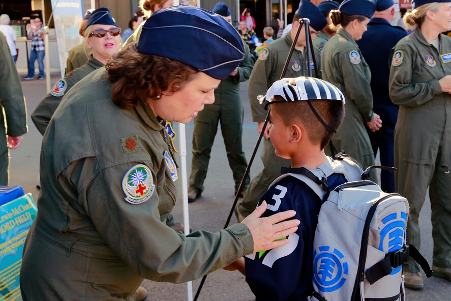 Maj. Sheila Wojewodzki, a 446th Aeromedical Evacuation Squadron flight nurse, out of Joint Base Lewis-McChord, Wash., checks to see if the dependent of a prospective recruit has any “Air Force Reserve” gear at the Washington State Fair, Puyallup, Wash., Sept. 18. Reservists from the wing’s aircraft maintenance, civil engineer, airlift, and aeromedical evacuation units participated in creating awareness for visitors, which generated more than 50 potential recruits. (U.S. Air Force Reserve photo by Master Sgt. Jake Chappelle)