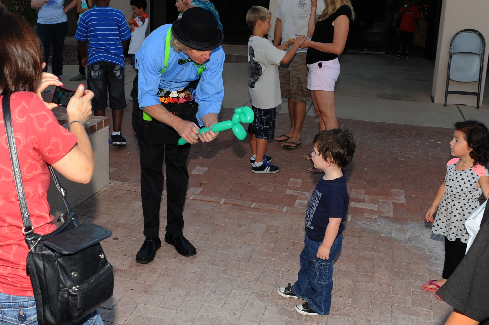 A balloon artist creates an animal for a military dependent during Jungle Journey at Davis-Monthan Air Force Base, Ariz. Sept. 19, 2013.  This event was open to all military dependents and included carnival games and a jungle-themed buffet. (U.S. Air Force photo by Airman 1st Class Chris Massey/Cropped)