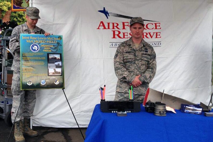 Tech. Sgt. Michael Robinson (left) and Senior Airman Jerrod Pilant, crew chiefs with the 446th Aircraft Maintenance Squadron at Joint Base Lewis-McChord, Wash. set up their mission-orientation display at the Washington State Fair in Puyallup, Wash., Sept. 16. Along with the 446th Airlift Wing recruiting team, they greeted fairgoers and came away with more than 50 potential recruits over a three-day period. (Photo courtesy of Master Sgt. Jack Cales)