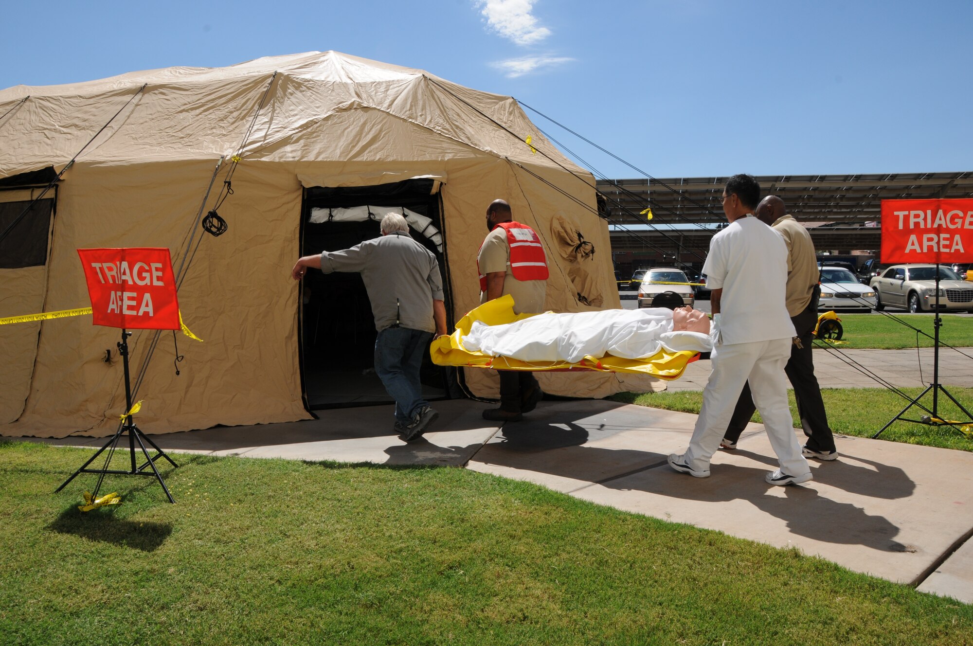 Carl Hayden Veterans Administration medical center employees carry a patient into a triage tent outside the hospital during Operation Swift Savior, a four day joint exercise. (U.S. Air Force photo/Tech. Sgt. Louis Vega Jr.)