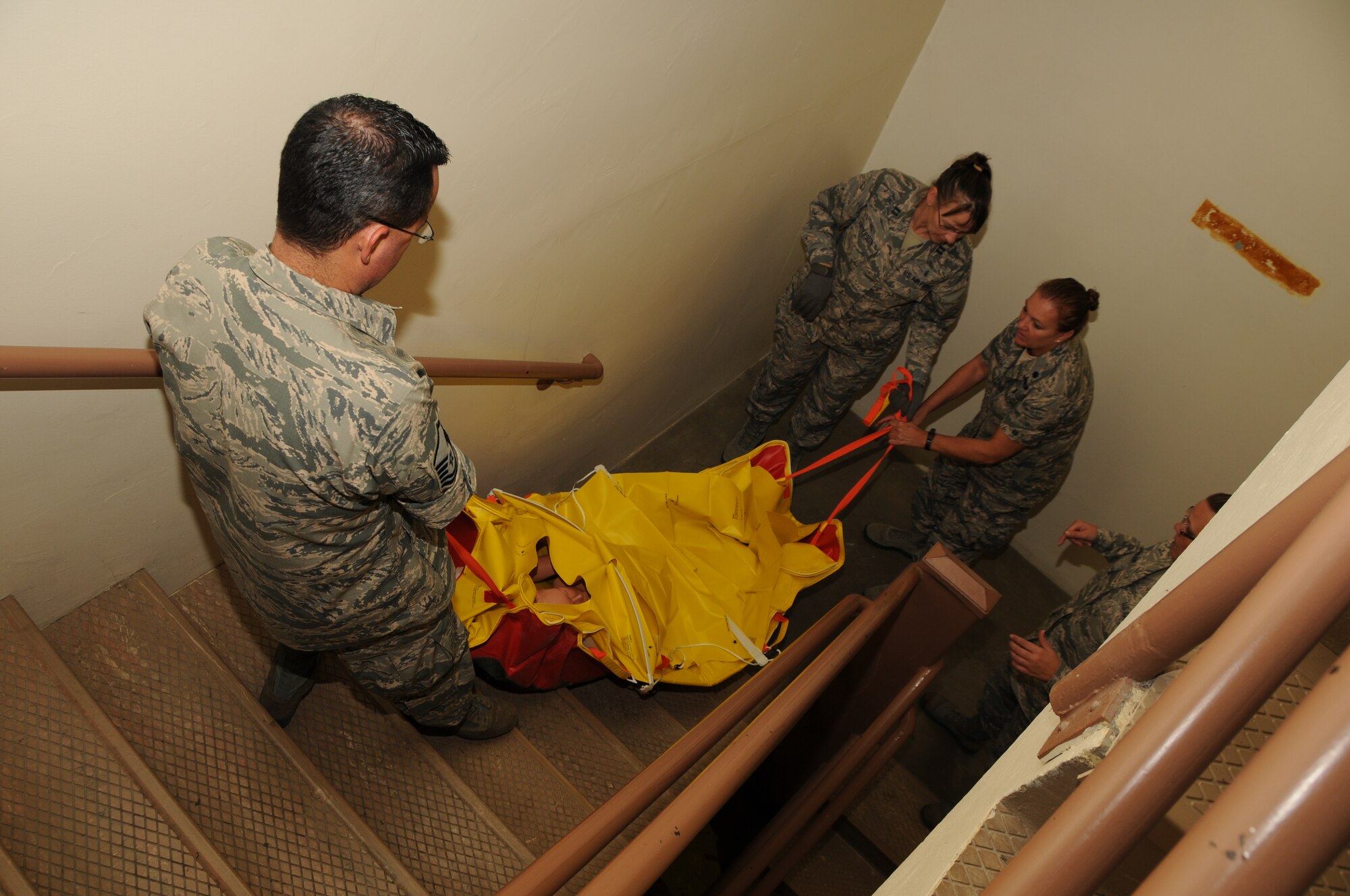 944th Aeromedical Staging Squadron members maneuver a patient down a flight of stairs at the Carl Hayden Veterans Administration medical center in Phoenix, Ariz. during Operation Swift Savior, a four day joint exercise. (U.S. Air Force photo/Tech. Sgt. Louis Vega Jr.)