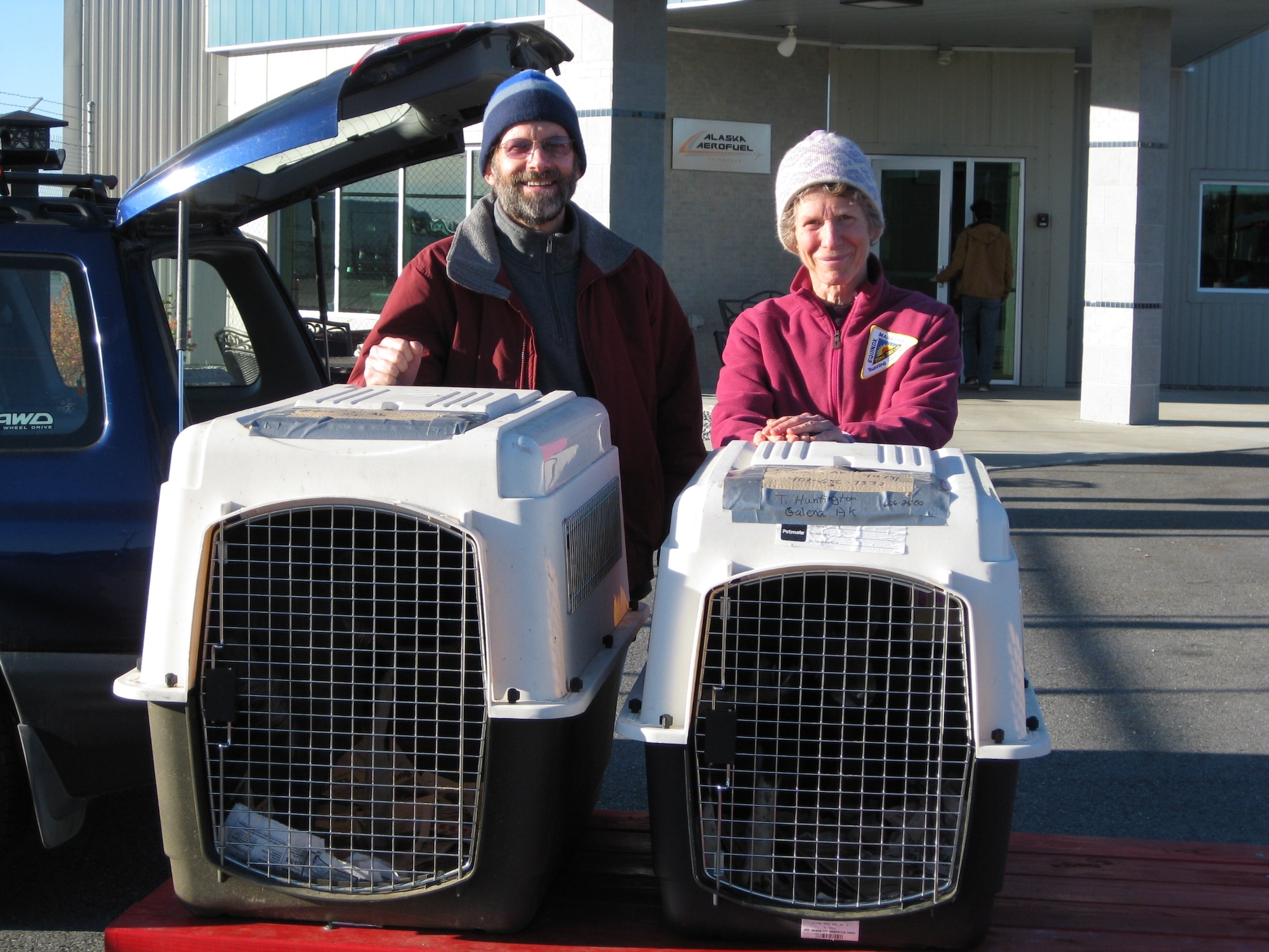 FAIRBANKS, Alaska - Members of the non-profit sled dog rescue “Second Chance League” pose with Cruger and Tiny as they prepare to fly out of Fairbanks Airport on September 16th. (U.S. Air Force photo/Bill Hughes)