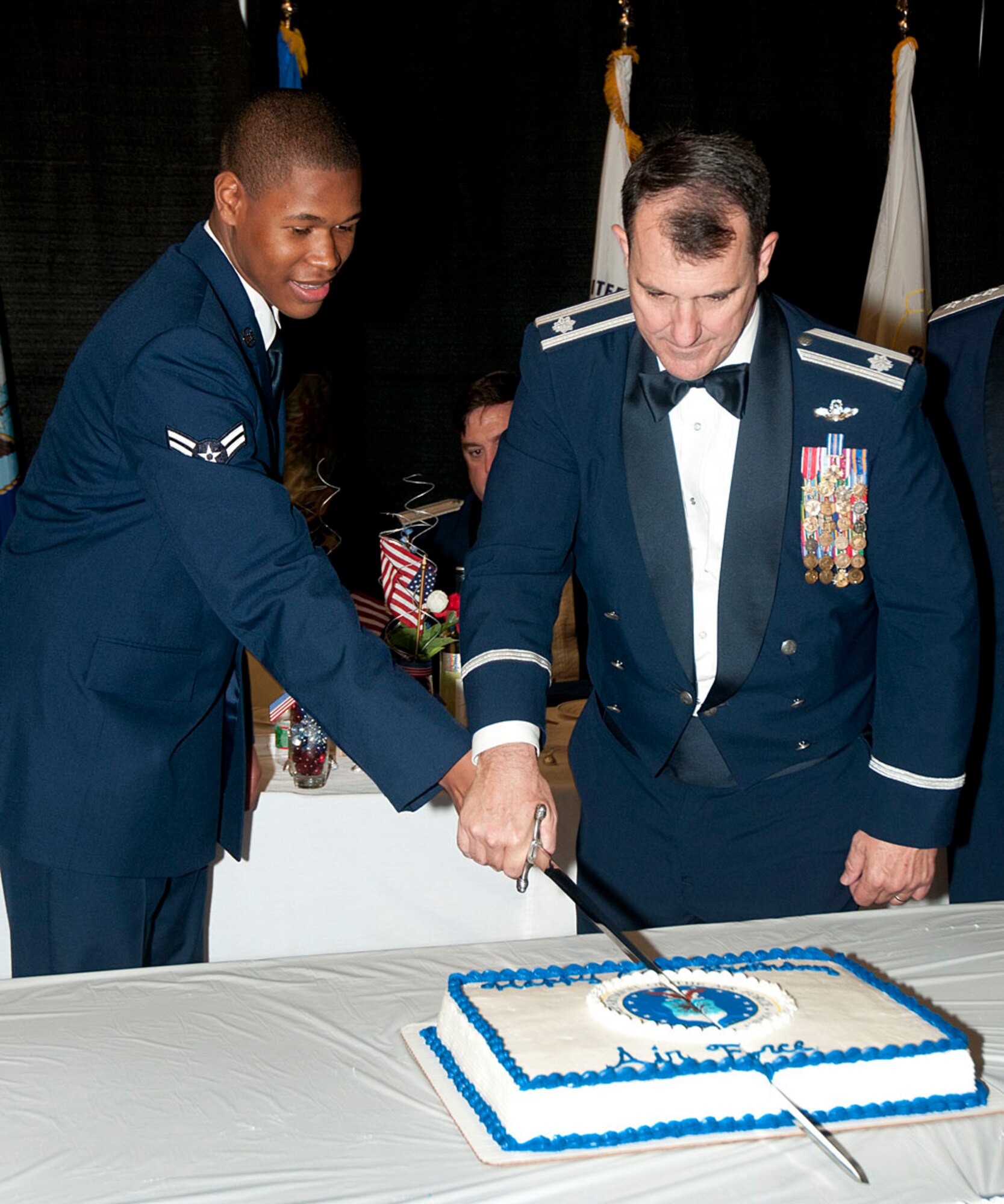 HANSCOM AIR FORCE BASE, Mass. – Lt. Col. Daniel Pinkava (right), the oldest Airman attending the Air Force 66th Birthday Ball, and Airman 1st Class Carvie Goode, the youngest Airman attending the event, ceremonially cut the birthday cake in the Aero Club Hanger Sept. 19. The ball featured the former commander of the 66th Air Base Wing, Lt. Gen. Darrell D. Jones, as the guest speaker. (Courtesy photo)  