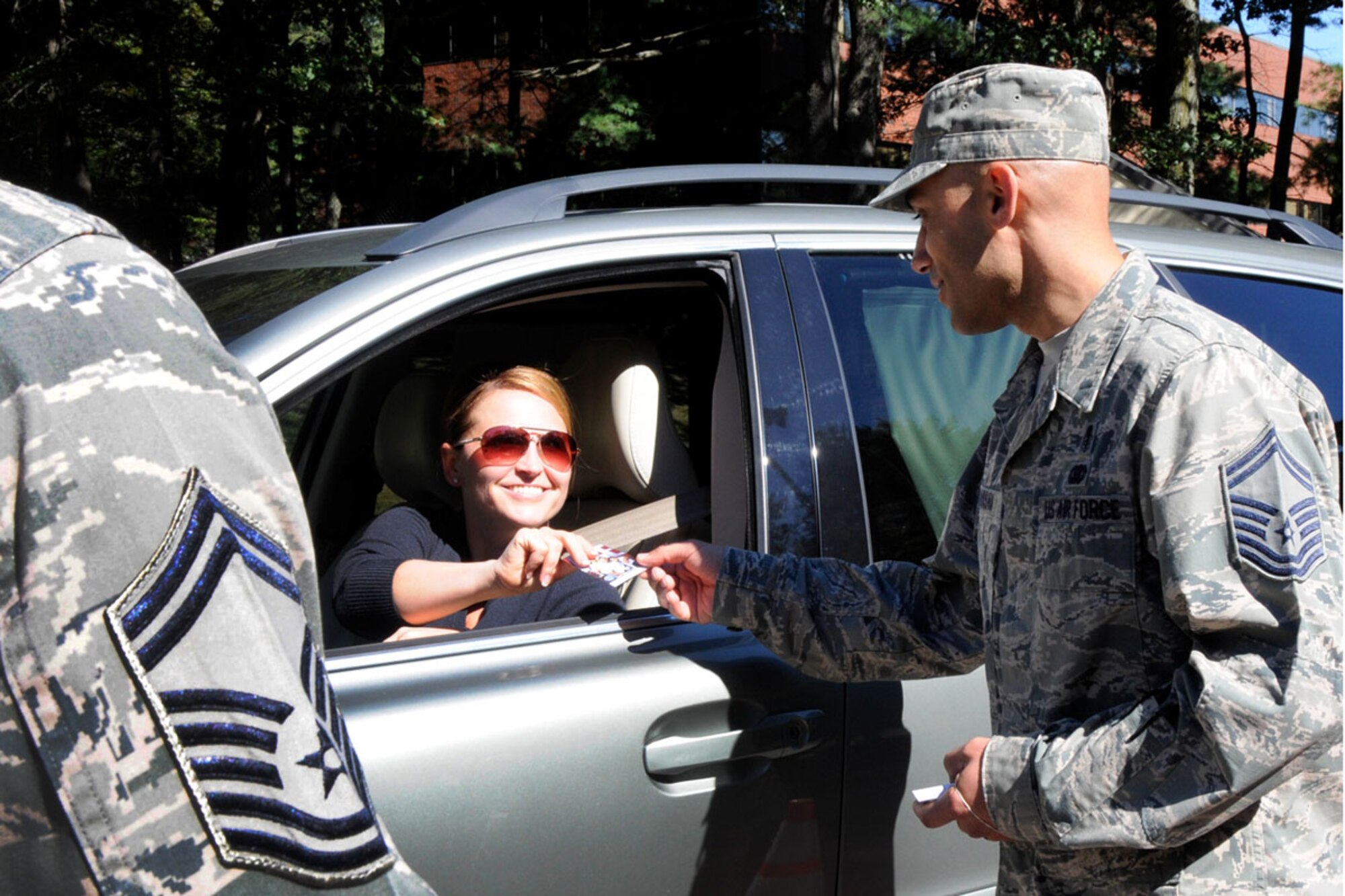 HANSCOM AIR FORCE BASE, Mass. – Senior Master Sgt. David Hassan, 66th Medical Squadron superintendent, hand an A.C.E. card to Shelly Kelley at the Vandenberg Gate Sept. 24. Senior leaders on base handed out the ACE (“A”sk your buddy, “C”are for your buddy and “E”scort) cards to promote a mechanism for suicide intervention. September is Suicide Prevention Awareness Month. (U.S. Air Force photo by Linda LaBonte Britt)