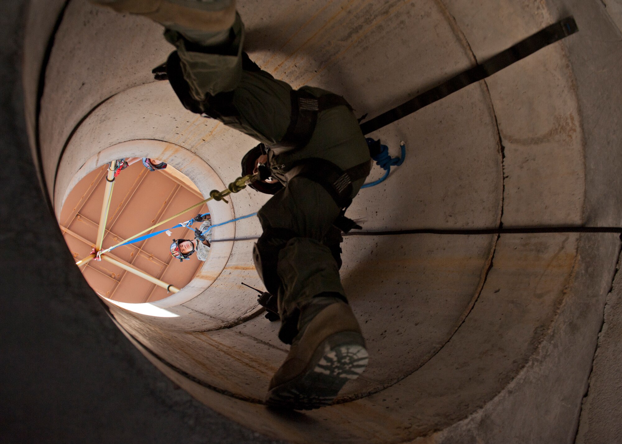 Airman 1st Class Ryan Oke, 49th Civil Engineering Squadron Fire Protection Flight firefighter, lifts Senior Airman Tyler Clemons, 49th Civil Engineering Squadron Fire Protection Flight firefighter after completing a confined space training exercise at Holloman Air Force Base, N.M., Sept. 25. Firefighters from the 49th CES performed a series of training exercises during the 49th Wing’s Unit Effectiveness Inspection Sept. 25 – 29. Holloman AFB is the first base in the Air Combat Command to undergo a UEI under the Air Force’s new inspection system, announced in August. (U.S. Air Force photo by Airman 1st Class Aaron Montoya/Released)