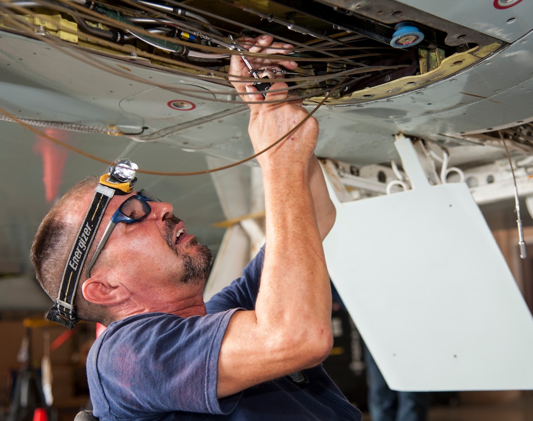 Ralph Martinez, 47th Maintenance Directorate aircraft mechanic, reconnects the flight control cables on a T-38 Talon aircraft at Laughlin Air Force Base, Texas, Sept. 18, 2013. Ailerons, elevators and rudder surfaces are actuated or trimmed by the use of control cables. (U.S. Air Force photo/Senior Airman Nathan Maysonet)