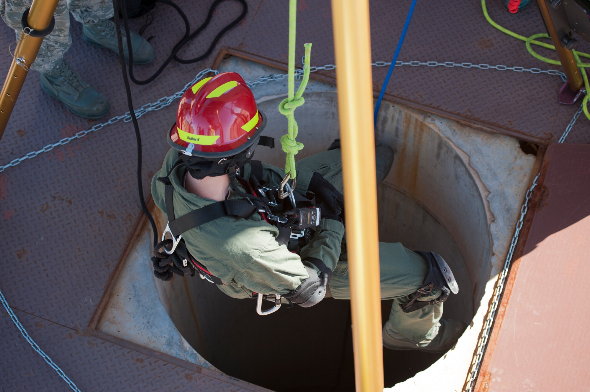 Staff Sgt. Justin Stacey, 49th Civil Engineering Squadron Fire Protection Flight firefighter, descends in to a space to secure and retrieve a simulated casualty during a confined space training exercise at Holloman Air Force Base, N.M., Sept. 25. Firefighters from the 49th CES performed a series of training exercises during the 49th Wing’s Unit Effectiveness Inspection Sept. 25 – 29. Holloman AFB is the first base in the Air Combat Command to undergo a UEI under the Air Force’s new inspection system, announced in August. (U.S. Air Force photo by Airman 1st Class Aaron Montoya/Released)