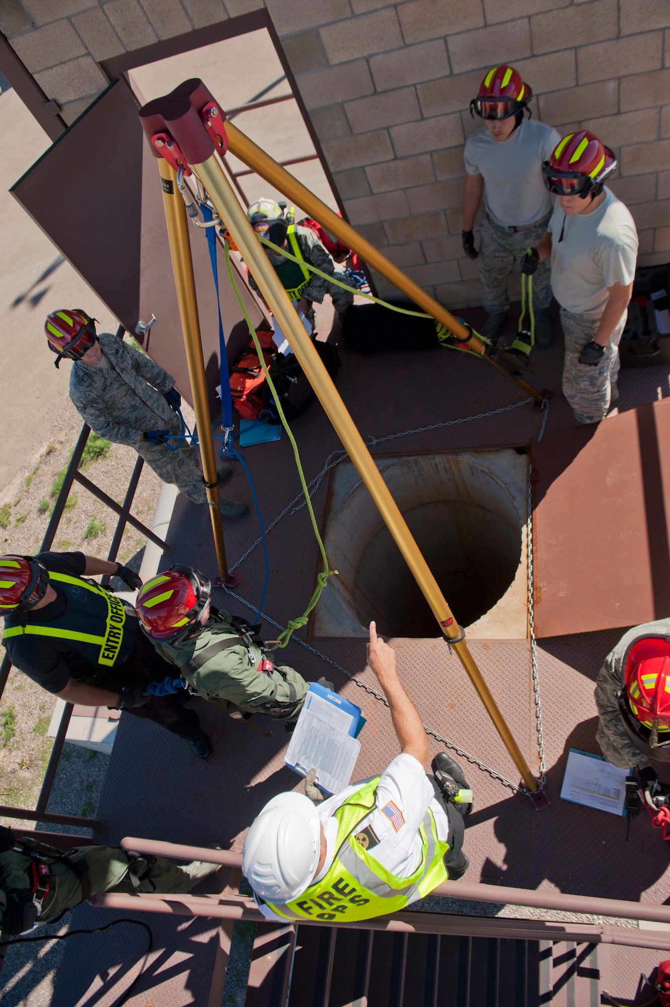 Richard Adler, 49th Civil Engineering Squadron Fire Protection Flight chief, briefs the firefighters before performing a confined space training exercise, in which a firefighter will be lowered into a space to secure and retrieve a simulated casualty, at Holloman Air Force Base, N.M., Sept. 26. Firefighters from the 49th CES performed a series of training exercises during the 49th Wing’s Unit Effectiveness Inspection Sept. 25 – 29. Holloman AFB is the first base in the Air Combat Command to undergo a UEI under the Air Force’s new inspection system, announced in August. (U.S. Air Force photo by Airman 1st Class Aaron Montoya/Released). 