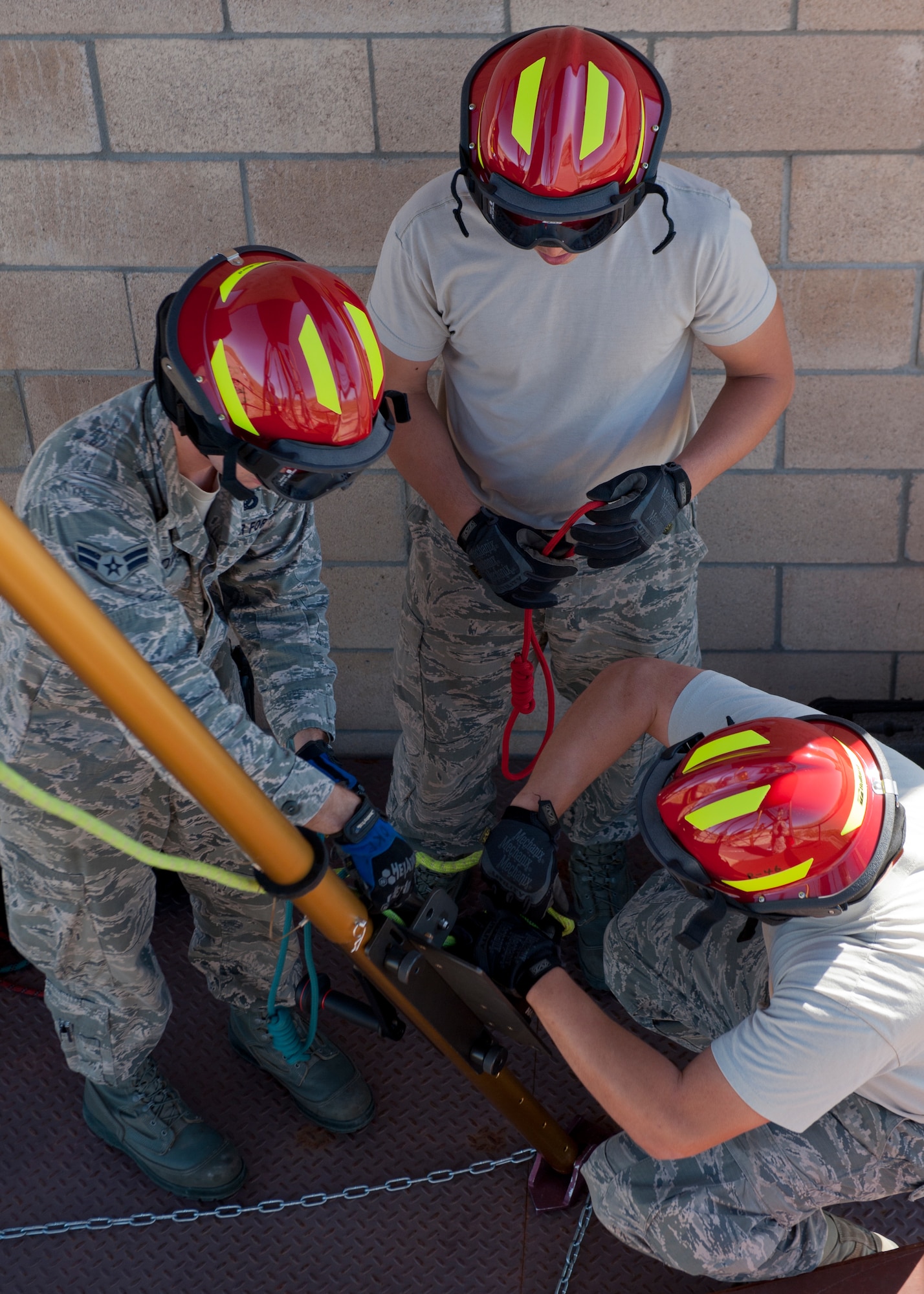 Airmen 1st Class Ryan Oke and John Murray and Senior Airman Gerrit Beernick, 49th Civil Engineering Squadron Fire Protection Flight firefighters, secure safety ropes to the rescue tripod during a confined space training exercise at Holloman Air Force Base, N.M., Sept. 25. Firefighters from the 49th CES performed a series of training exercises during the 49th Wing’s Unit Effectiveness Inspection Sept. 25 – 29. Holloman AFB is the first base in the Air Combat Command to undergo a UEI under the Air Force’s new inspection system, announced in August. (U.S. Air Force photo by Airman 1st Class Aaron Montoya/Released)