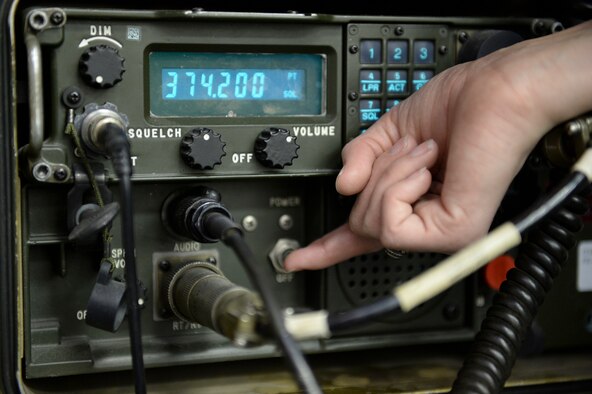 U.S. Air Force Airman 1st Class Kierrea Clary, 18th Aggressor Squadron aviation resource manager, operates a Track 176 UHF/VHF radio at 18th AGRS headquarters Sept. 24, 2013, Eielson Air Force Base, Alaska. Clary maintains constant radio contact with pilots and maintenance crews to track events and keeps personnel informed with changing situations during sorties. (U.S. Air Force photo by Airman 1st Class Peter Reft/Released)