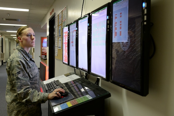 U.S. Air Force Airman 1st Class Kierrea Clary, 18th Aggressor Squadron aviation resource manager, manages the hallway monitor at 18th AGRS headquarters Sept. 24, 2013, Eielson Air Force Base, Alaska. Clary uses the monitor to keep track of pilot training, flight schedules and maintenance issues. (U.S. Air Force photo by Airman 1st Class Peter Reft/Released)
