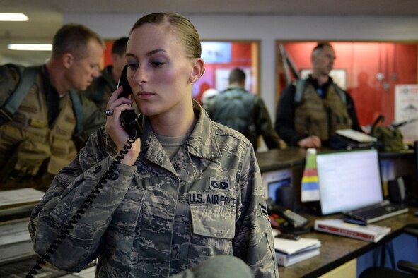 U.S. Air Force Airman 1st Class Kierrea Clary, 18th Aggressor Squadron aviation resource manager, verifies flight checklists during a pilot go and no- go procedure at 18th AGRS headquarters Sept. 24, 2013, Eielson Air Force Base, Alaska. Clary ensured pilots completed their pre-flight checklist requirements prior to flying.  (U.S. Air Force photo by Airman 1st Class Peter Reft/Released)