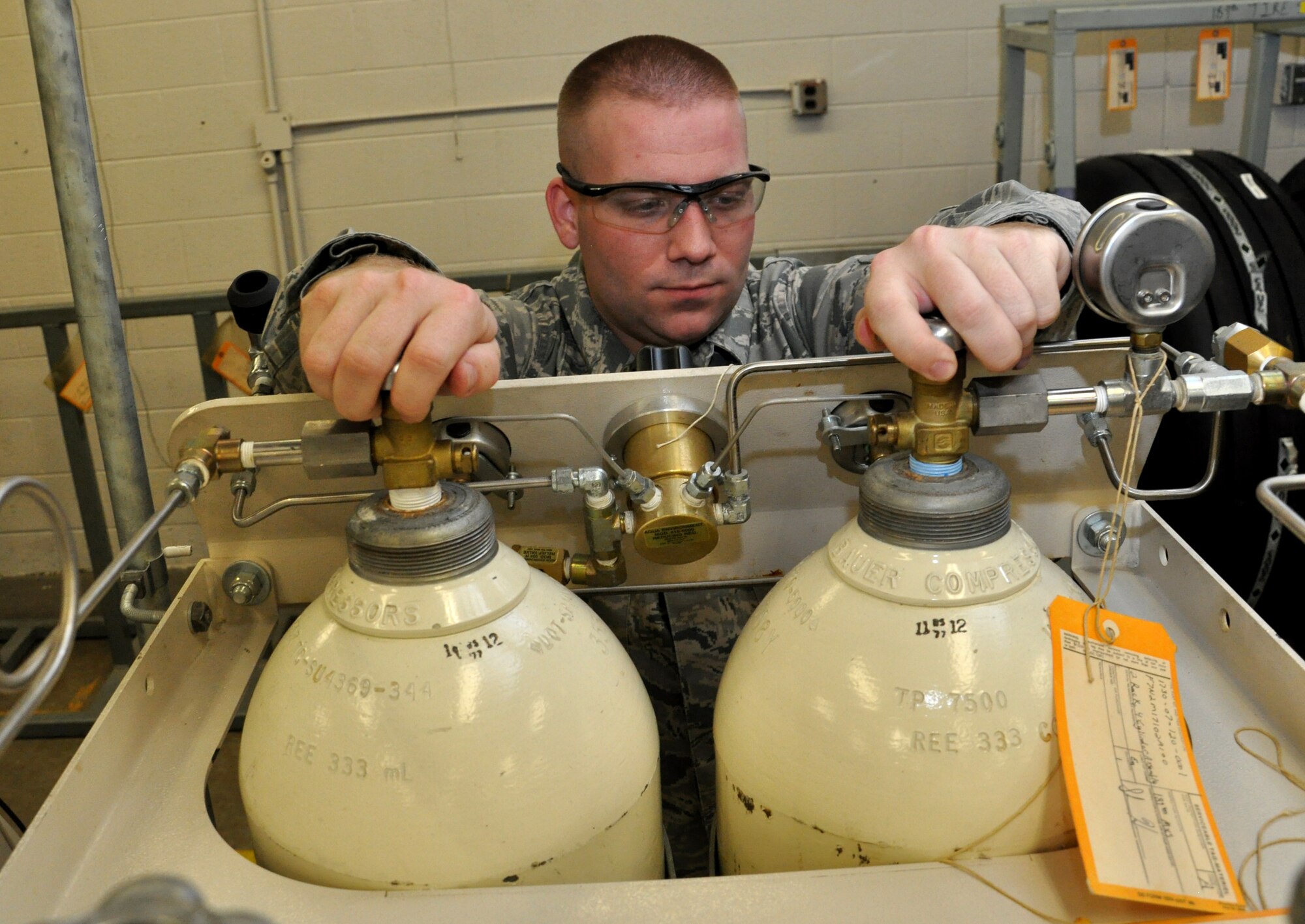 Senior Airman David Rogers, a 189th Aircraft Maintenance Squadron repair and reclamation journeyman, opens valves that release nitrogen over to the tire filling cage Sept. 24, 2013, at Little Rock Air Force Base, Ark. Rogers, a North Little Rock, Ark., native, also works on flight controls as well as building and tearing down landing gear. (U.S. Air Force photo by Senior Airman Regina Agoha)