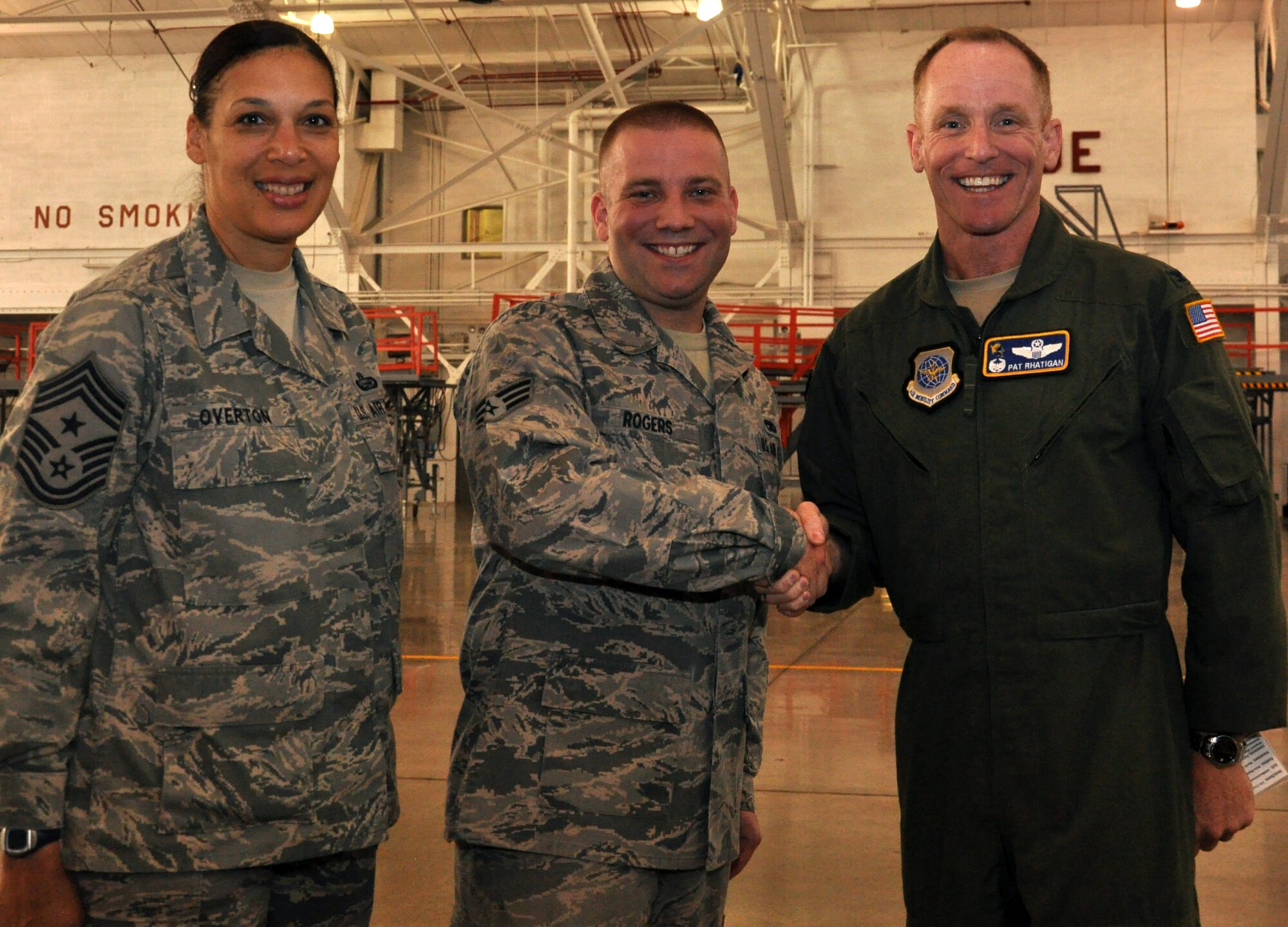 Col. Patrick Rhatigan, 19th Airlift Wing commander, along with Chief Master Sgt. Margarita Overton, 19th AW command chief, congratulate Senior Airman David Rogers, a 189th Aircraft Maintenance Squadron repair and reclamation journeyman, for his selection as Combat Airlifter of the Week Sept. 24, 2013, at Little Rock Air Force Base, Ark. Rogers volunteered for the rapid augmentation team, which aids communities during or after a natural disaster. (U.S. Air Force photo by Senior Airman Regina Agoha)