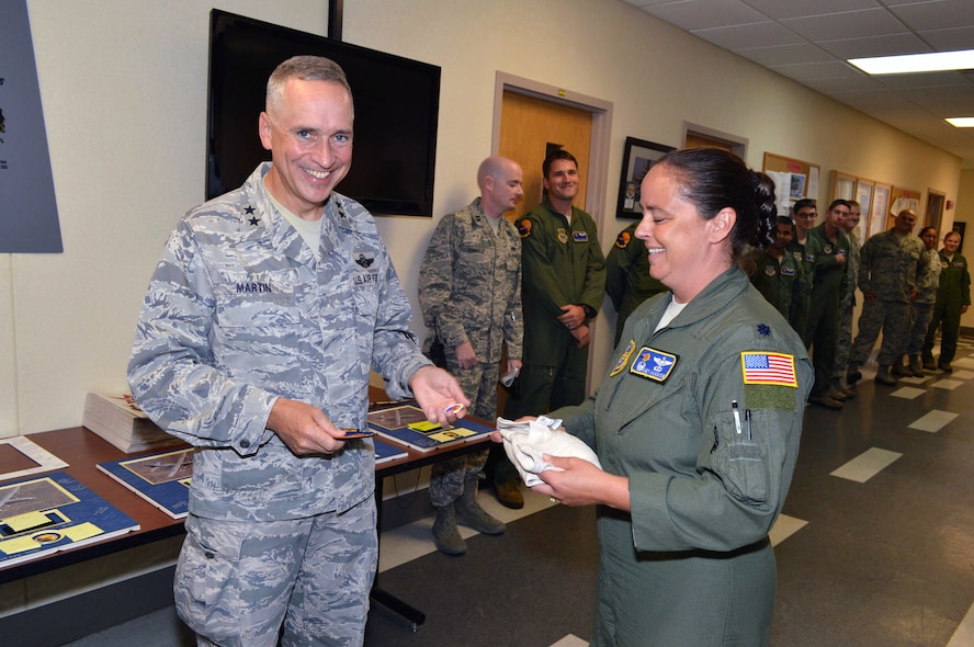 Lt. Col. Amy Jardon, 2d Airlift Squadron commander, presents Maj. Gen. Rick Martin, U.S. Air Force Expeditionary Center commander, with 2d Airlift Squadron memorabilia, during his visit to Pope Army Airfield, N.C. on Sep 16 to see first-hand how the 43d Airlift Group Airmen support the Global Response Force mission.  (U.S. Air Force Photo/Marvin Krause)