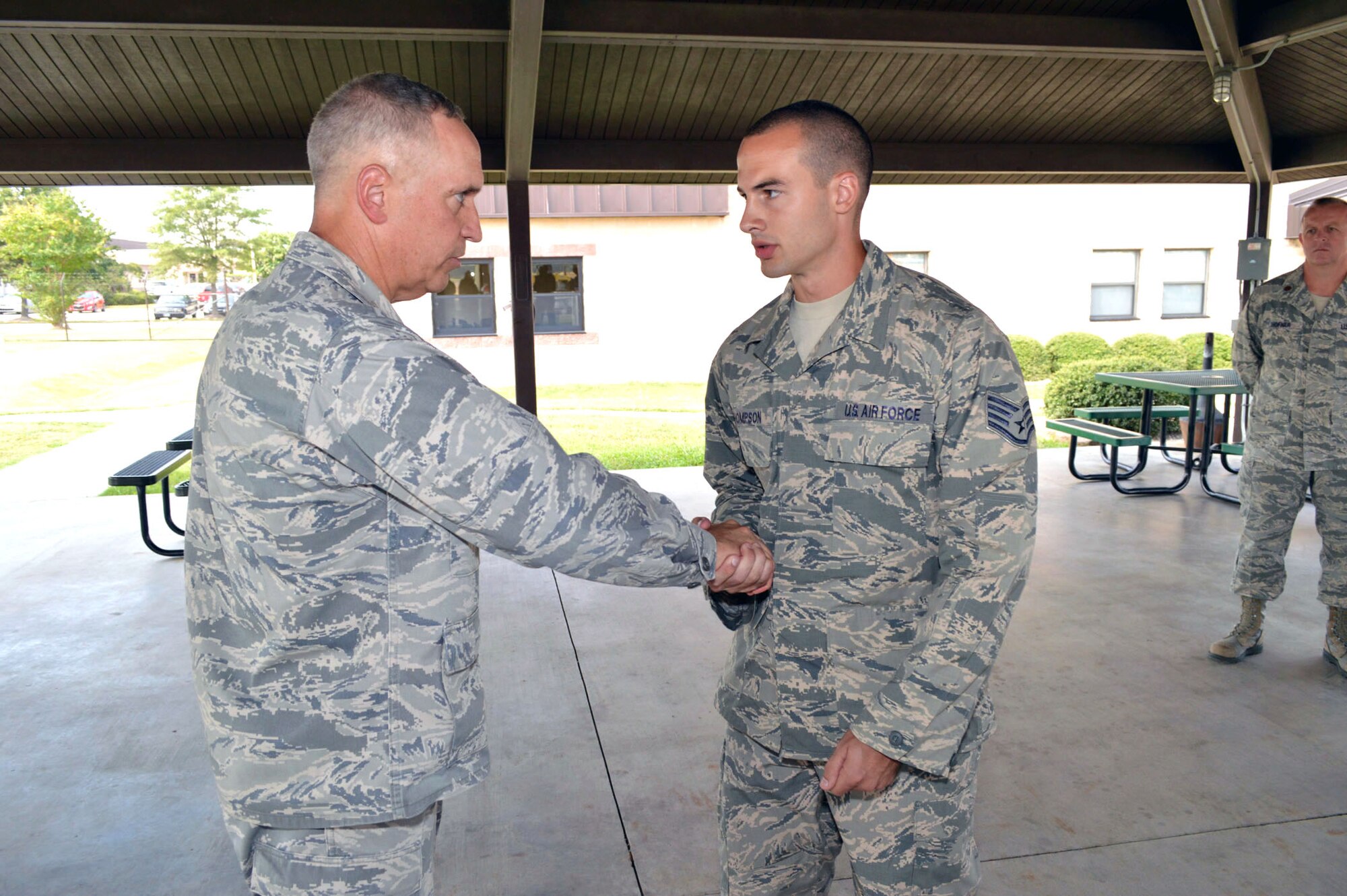 Maj. Gen. Rick Martin, U.S. Air Force Expeditionary Center commander, presents Staff Sgt. Joshua Thompson, 43d Aircraft Maintenance Squadron, with his coin during his tour of 43d Airlift Group units Sep 16.  Sergeant Thompson’s outstanding knowledge and skills were instrumental to the success of Joint Operational Access Exercise 13-03, the largest in a decade, enabling the safe launch of 154 sorties that delivered over 4,000 paratroopers with a 100 percent maintenance departure reliability rate.  General Martin visited Pope Army Airfield, N.C. to see first-hand how the 43d Airlift Group Airmen support the Global Response Force mission.  (U.S. Air Force Photo/Marvin Krause)
