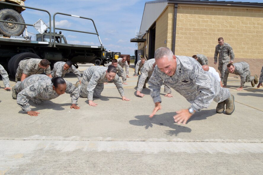 Maj. Gen. Rick Martin, U.S. Air Force Expeditionary Center commander, performs forty-six pushups with Airmen from the 3d Aerial Port Squadron after receiving a mission briefing from squadron leaders on Sep 16.  General Martin visited Pope Army Airfield, N.C. to see first-hand how the 43d Airlift Group Airmen support the Global Response Force mission.  (U.S. Air Force Photo/Marvin Krause)