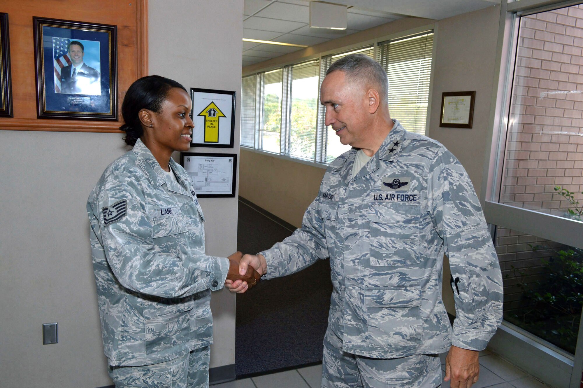 Maj. Gen. Rick Martin, U.S. Air Force Expeditionary Center commander, presents Staff Sgt. Tara Lane, 43d Airlift Group Command Post, with his coin during his tour of 43d Airlift Group units Sep 16.  Sergeant Lane’s leadership was evident during her recent deployment as a member of the 379th Air Expeditionary Wing’s Command Post, Southwest Asia, where she adeptly managed a $75,000 equipment account and optimized their distinguished visitor operations program.  General Martin visited Pope Army Airfield, N.C. to see first-hand how the 43d Airlift Group Airmen support the Global Response Force mission.  (U.S. Air Force Photo/Marvin Krause)
