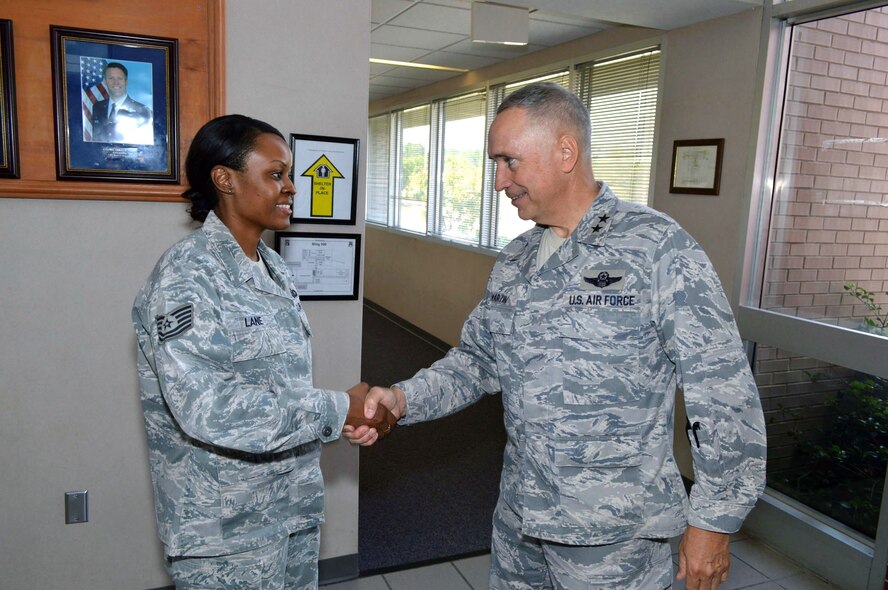 Maj. Gen. Rick Martin, U.S. Air Force Expeditionary Center commander, presents Staff Sgt. Tara Lane, 43d Airlift Group Command Post, with his coin during his tour of 43d Airlift Group units Sep 16.  Sergeant Lane’s leadership was evident during her recent deployment as a member of the 379th Air Expeditionary Wing’s Command Post, Southwest Asia, where she adeptly managed a $75,000 equipment account and optimized their distinguished visitor operations program.  General Martin visited Pope Army Airfield, N.C. to see first-hand how the 43d Airlift Group Airmen support the Global Response Force mission.  (U.S. Air Force Photo/Marvin Krause)
