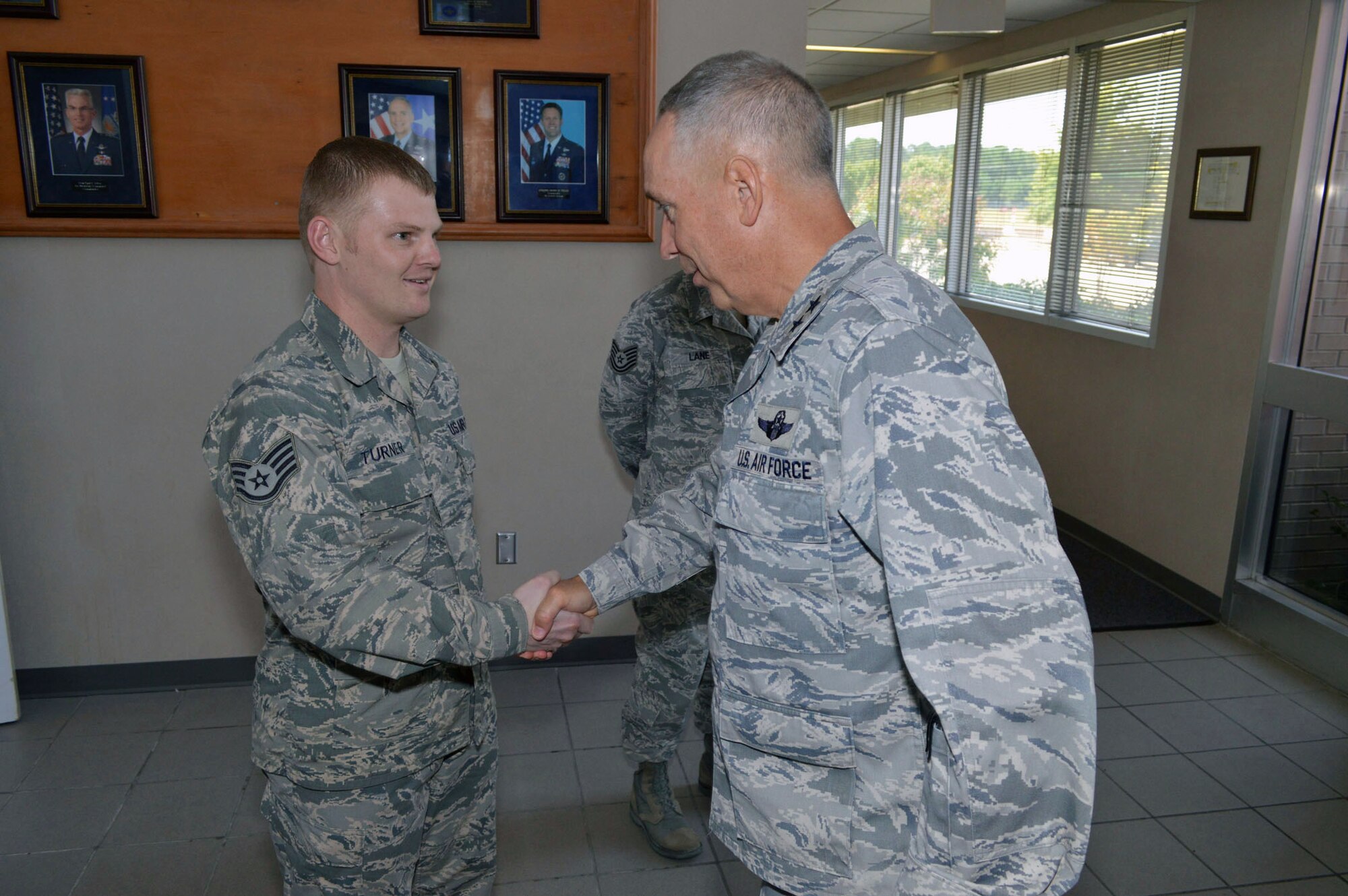 Maj. Gen. Rick Martin, U.S. Air Force Expeditionary Center commander, presents Staff Sgt. Mathew Turner, 43d Logistics Readiness Squadron, with his coin during his tour of 43d Airlift Group units Sep 16.  Sergeant Turner directs the squadron’s deployment manager program.  General Martin visited Pope Army Airfield, N.C. to see first-hand how the 43d Airlift Group Airmen support the Global Response Force mission.  (U.S. Air Force Photo/Marvin Krause)
