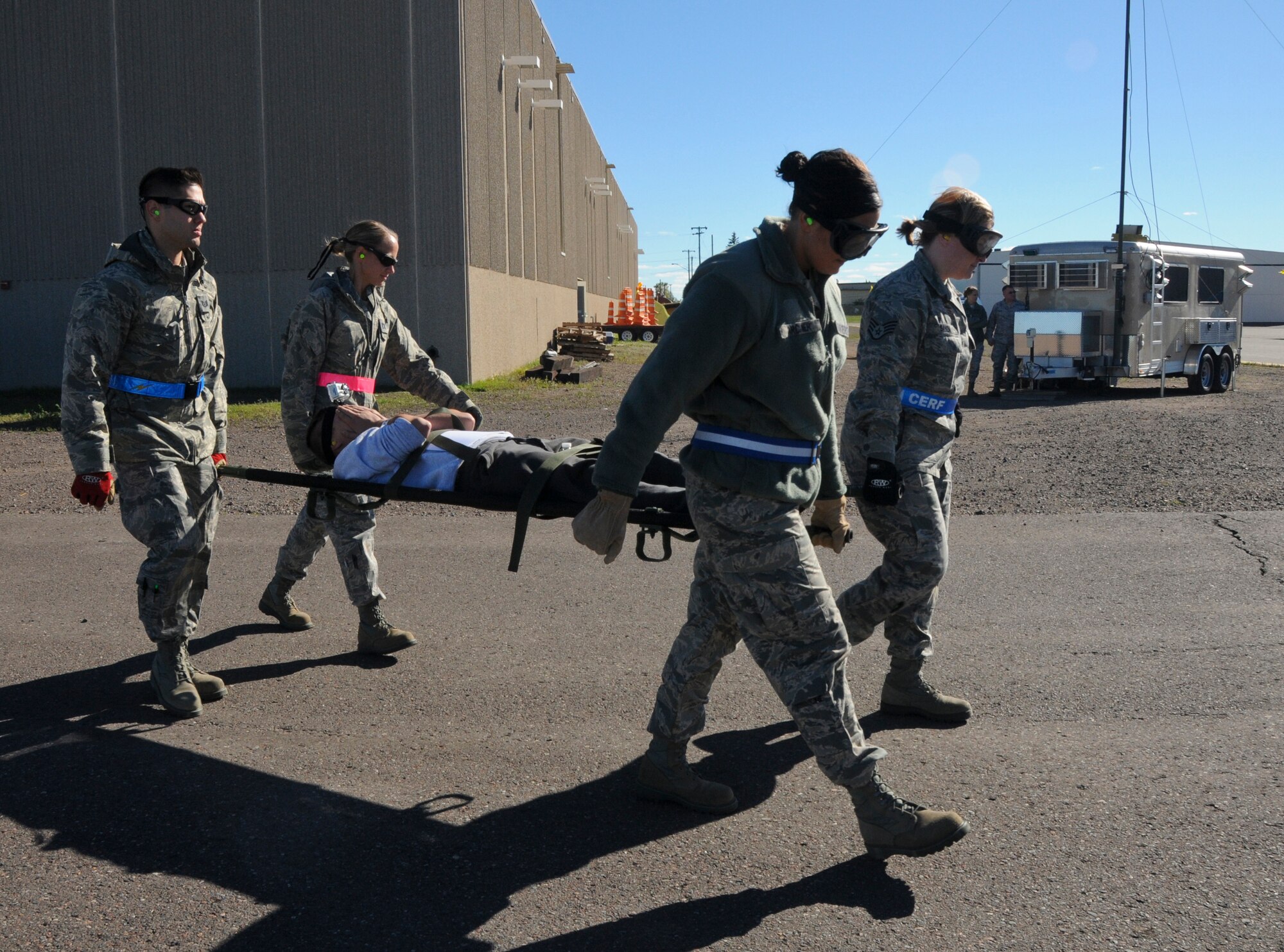 Airmen from the 133rd Airlift Wing, carry a patient to the C-130 as part of an Aeromedical Evacuation Flight from Duluth, Minnesota to the Twin Cities. The exercise simulated a terrorist incident in Duluth that resulted in civilian evacuations to the Twin Cities and Camp Ripley. The training partnered with 14 civilian agencies and utilized many of the 133AW capabilities to help both Airmen and civilians react better when facing disasters. (U.S. Air National Guard photo by Senior Airman Kari Giles.)