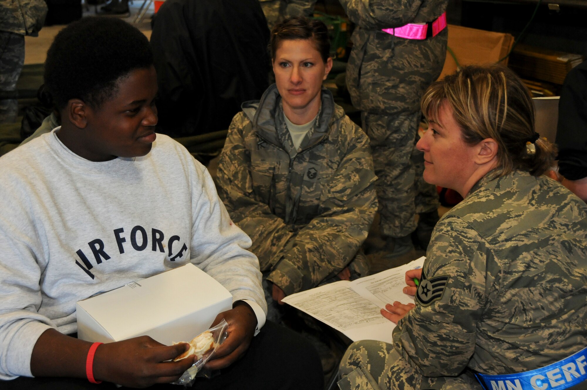 SSgt. Merci Sand with the 133rd Airlift Wing, checks in a patient, making sure he is stable and flight ready before he needs to board the C-130 in Duluth, Minnesota. The exercise simulated a terrorist incident in Duluth that resulted in civilian evacuations to the Twin Cities and Camp Ripley. The training partnered with 14 civilian agencies and utilized many of the 133AW capabilities to help both Airmen and civilians react better when facing disasters. (U.S. Air National Guard photo by Senior Airman Kari Giles.)